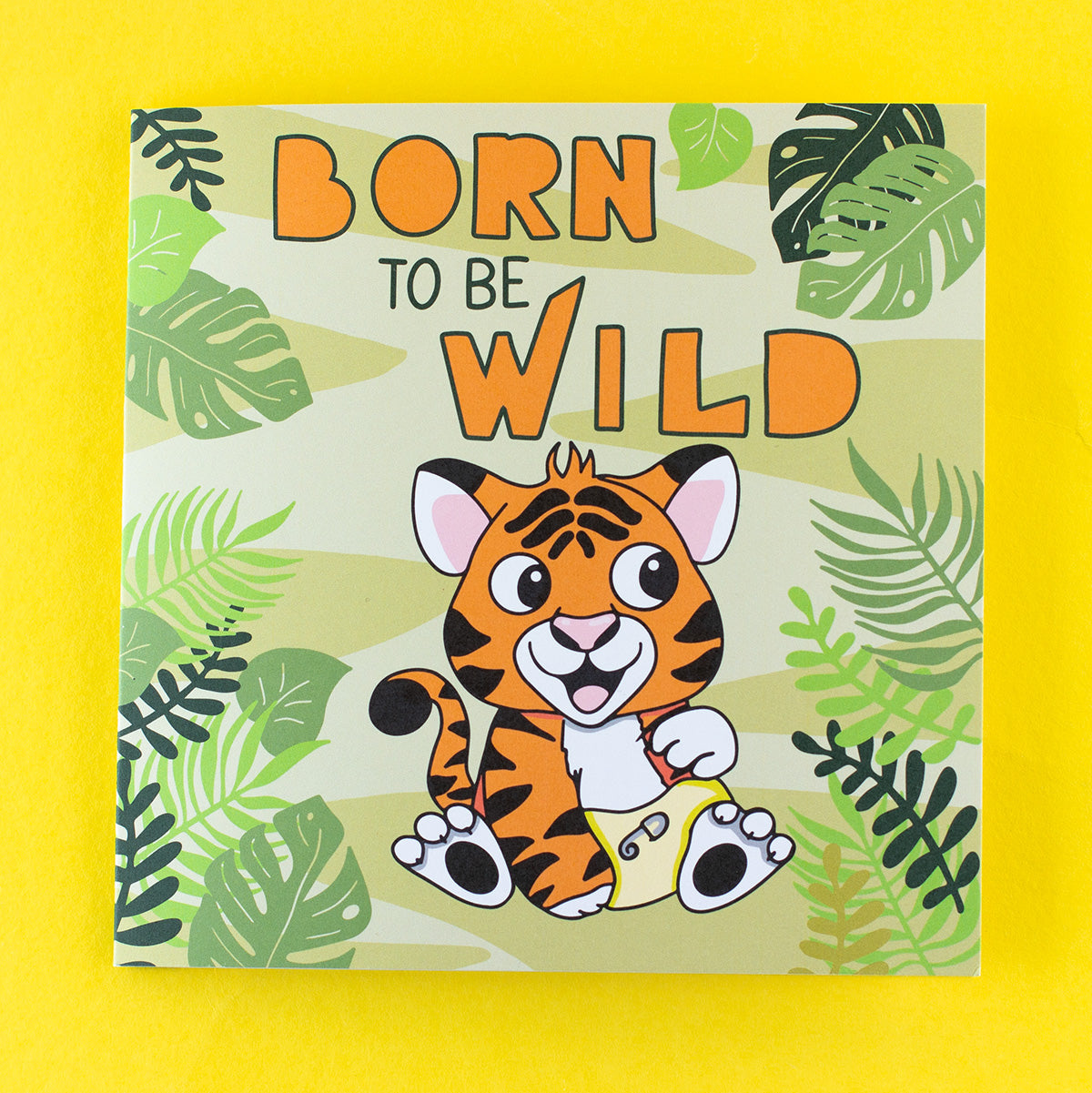 New Baby card with a cute tiger cub wearing a nappy in the jungle with the words born to be wild.
