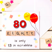 80 is only 13 in Scrabble. illustrated 80th Birthday card with Birthday balloons and confetti and hand finished with wooden scrabble tiles