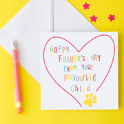A white card with colourful letters saying Happy Father's Day from your favourite child with a yellow paw print and red line heart drawn around it. Father's Day card designed to be from the dog or cat. Image shows it with a white envelope on a yellow background