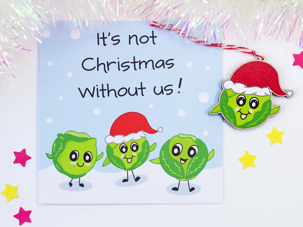 Christmas Card and Christmas Decoration, ornament. Card has 3 happy sprouts, one wearing a santa hat. Words say It's Not Christmas without us! Matching Christmas wooden hanging decoration of the sprout with a Santa hat