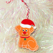 Gingerbread style dog wooden decoration with a Santa hat and festive collar.