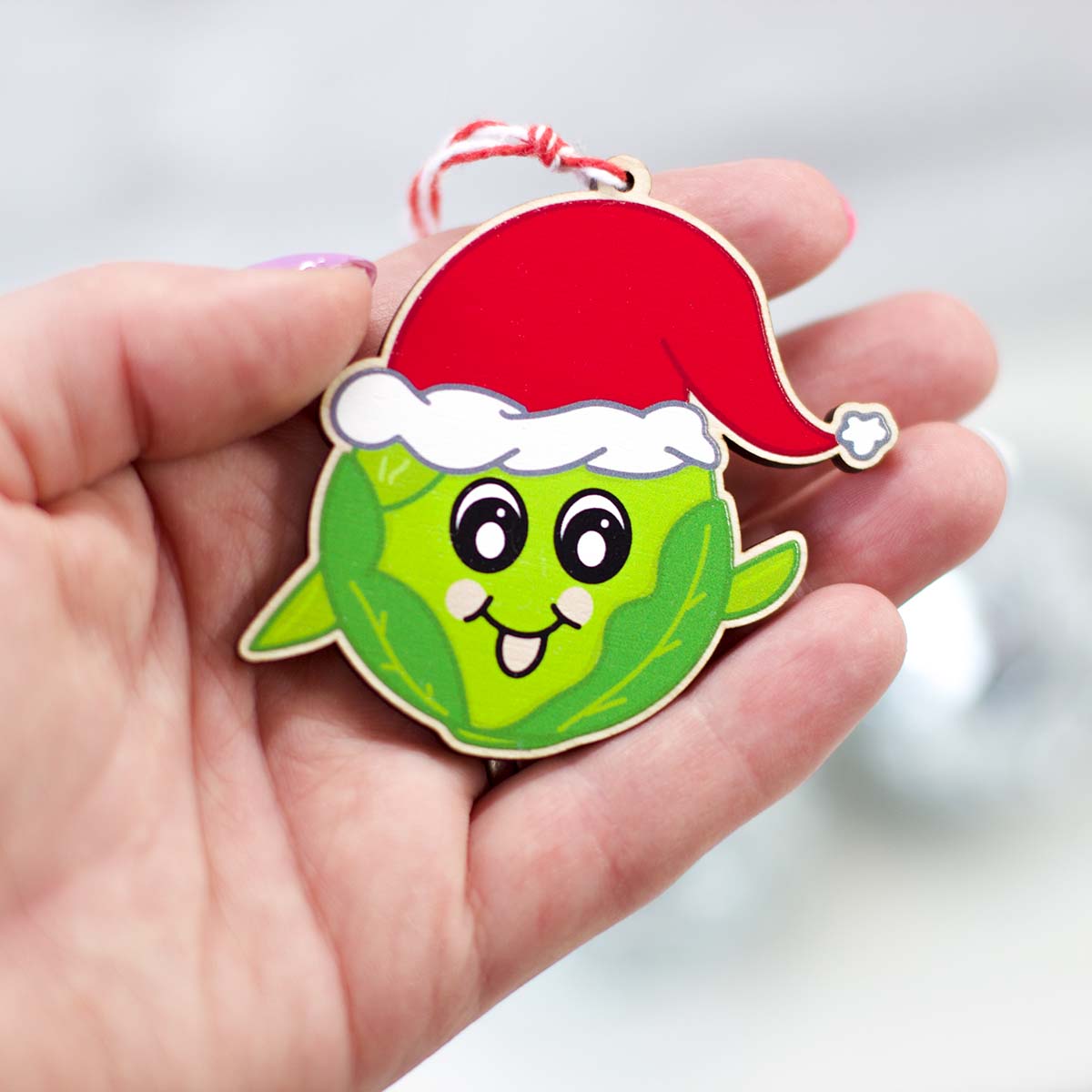 Sprout Christmas decoration in the palm of a hand