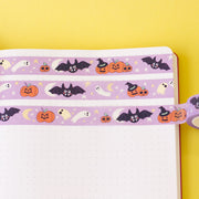 Cute Halloween Bats, pumpkins and ghosts on Washi Tape with a purple background in a bullet journal. Colourful Halloween Washi Tape designed by fizzi~jayne