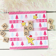 Ho Ho Ho Christmas cards surrounded by tinsel and  wooden scrabble tiles