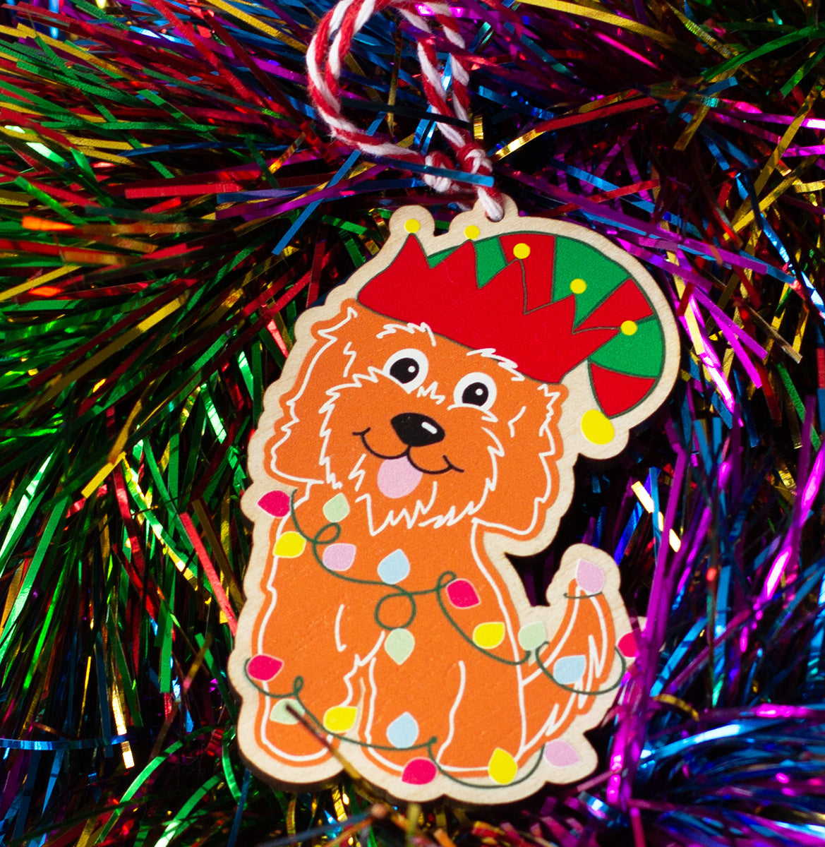 Gingerbread Cockapoo Wooden Tree Decoration with Christmas tree fairy lights wrapped around the dog and wearing an elf's hat