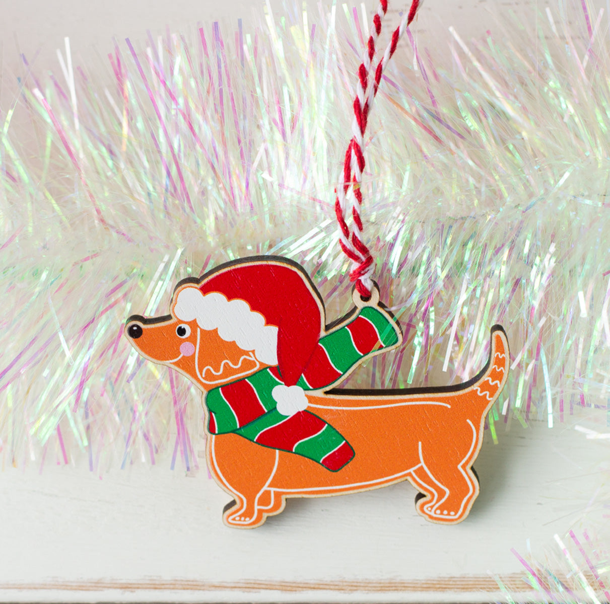 Gingerbread style Dachshund Christmas tree decoration with red and white twine for hanging.