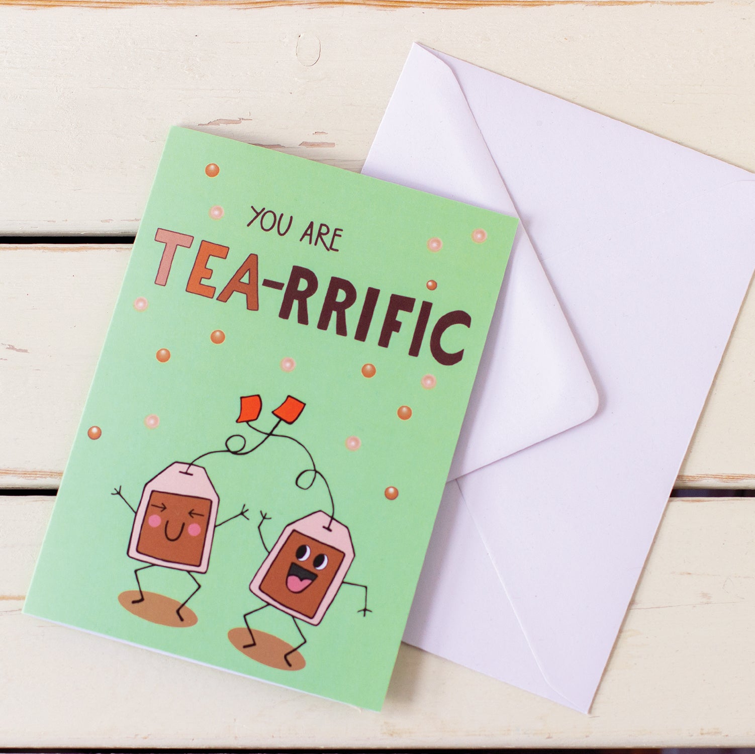 illustrated card of happy, dancing tea bags with words You Are Tea-Riffic with white envelope illustration by fizzy jane